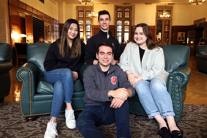 Group of smiling Cox Scholars, sitting together.